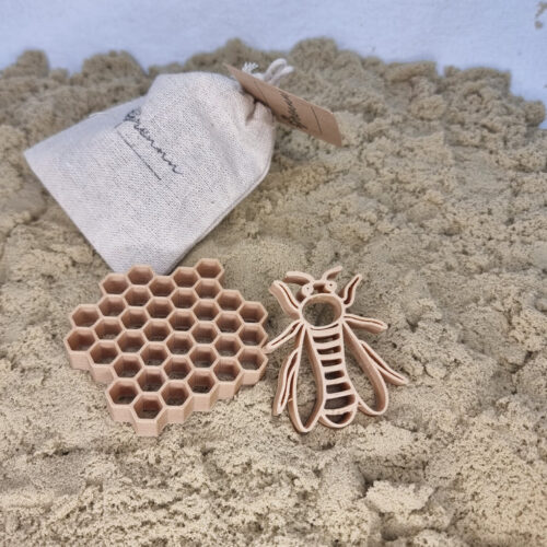 Grennn bij en honingraat uitsteker in zand