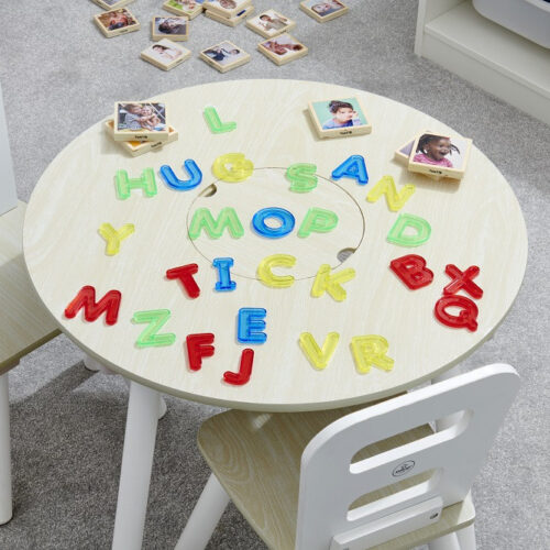 Doorzichtige gekleurde letters in hoofdletters op tafel